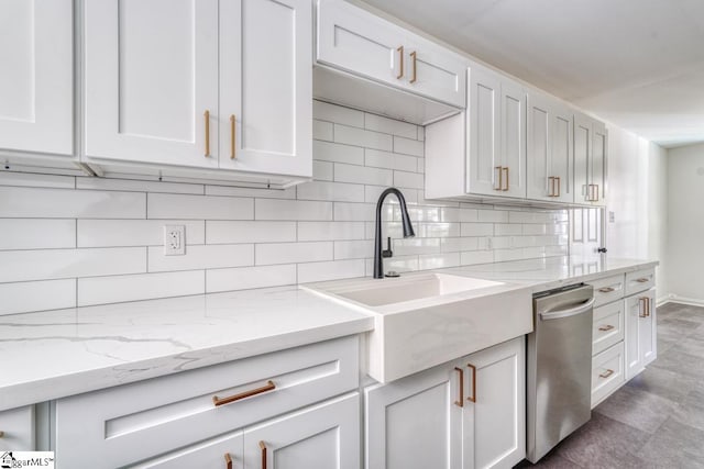 kitchen featuring sink, decorative backsplash, and white cabinetry