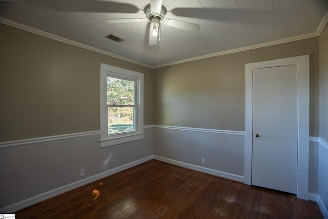 unfurnished room with crown molding, dark hardwood / wood-style floors, and ceiling fan