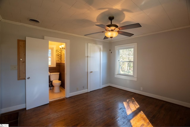 unfurnished bedroom featuring ceiling fan, crown molding, ensuite bathroom, and dark hardwood / wood-style floors