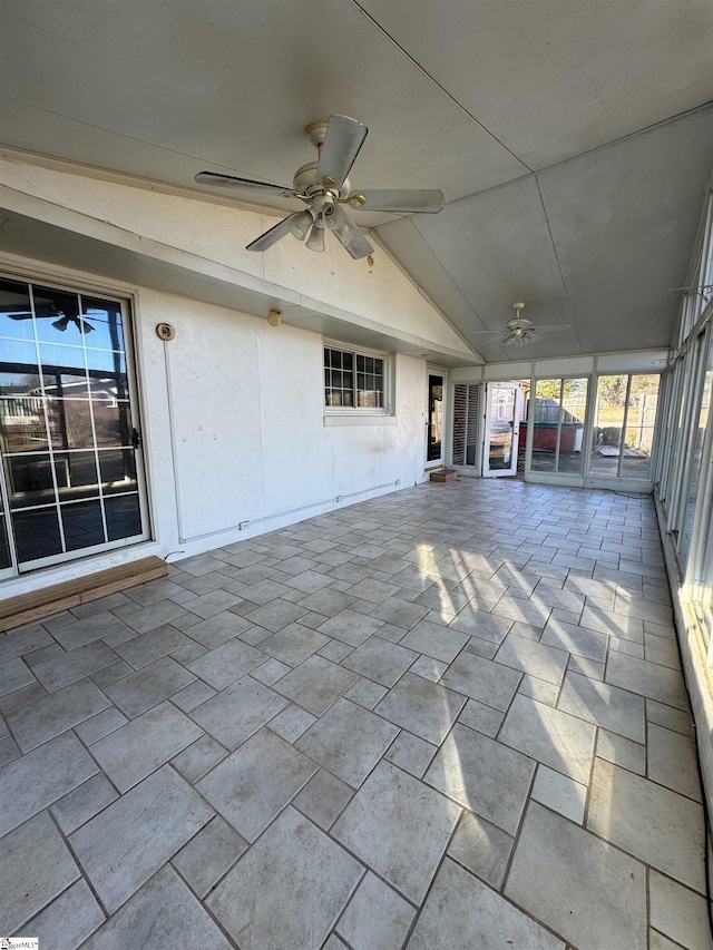 unfurnished sunroom with ceiling fan and lofted ceiling