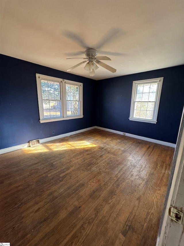 empty room featuring hardwood / wood-style floors and ceiling fan