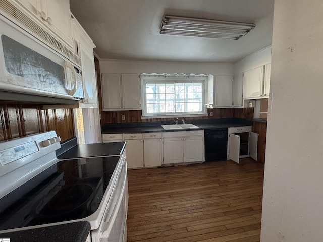 kitchen featuring dark hardwood / wood-style flooring, sink, white cabinets, and white appliances