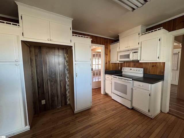 kitchen featuring crown molding, white cabinets, wood-type flooring, and white appliances