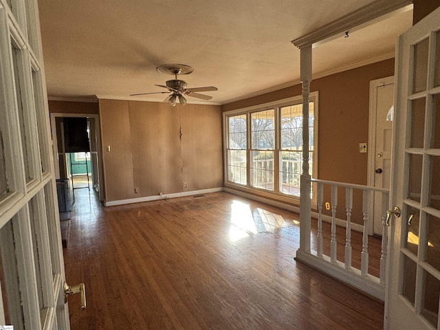 empty room featuring ceiling fan, dark hardwood / wood-style flooring, and ornamental molding