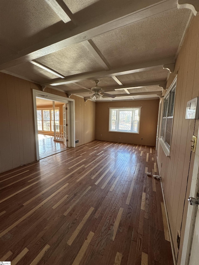 interior space featuring ceiling fan, dark hardwood / wood-style floors, wooden walls, and coffered ceiling