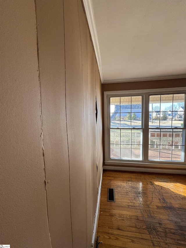 room details with hardwood / wood-style flooring and crown molding