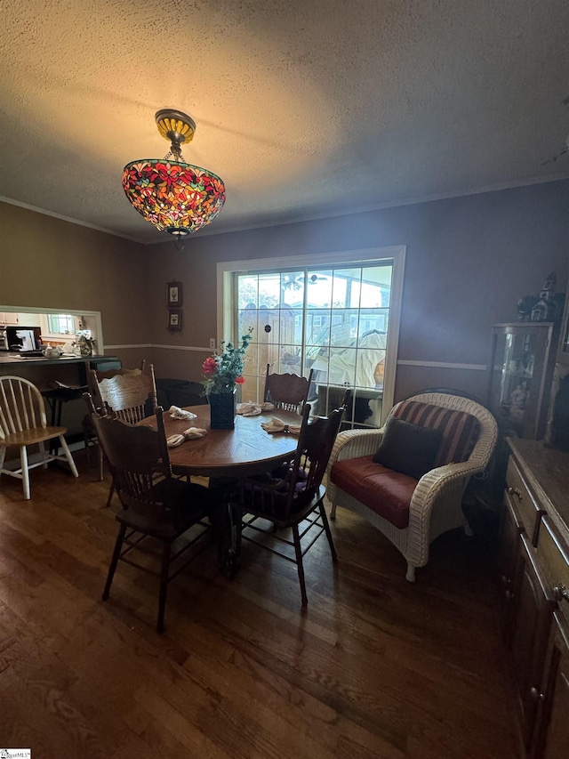 dining area featuring a textured ceiling and dark hardwood / wood-style flooring