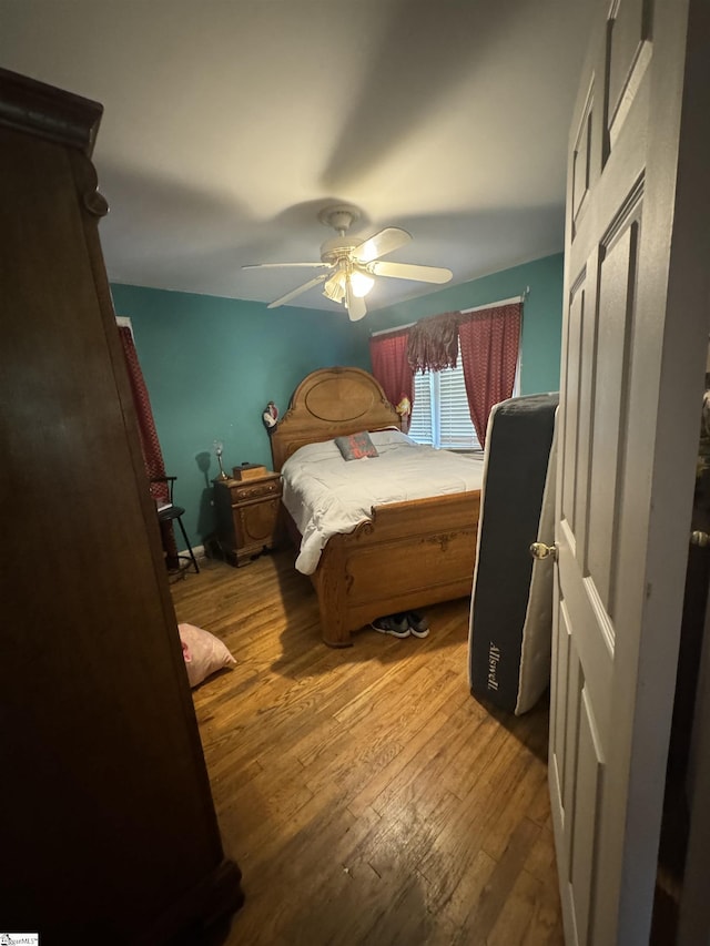 bedroom featuring wood-type flooring and ceiling fan