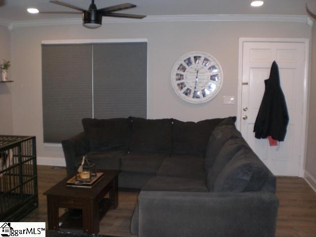 living room featuring crown molding, hardwood / wood-style flooring, and ceiling fan