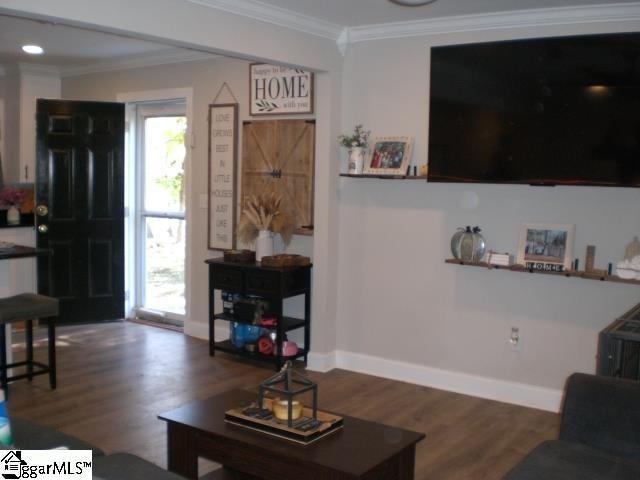 living room featuring ornamental molding and dark hardwood / wood-style flooring