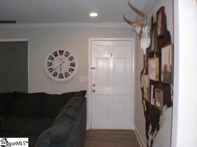 living room featuring crown molding and hardwood / wood-style floors