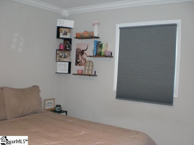 bedroom with ornamental molding