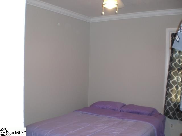 bedroom with crown molding