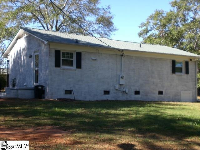 rear view of house featuring a yard