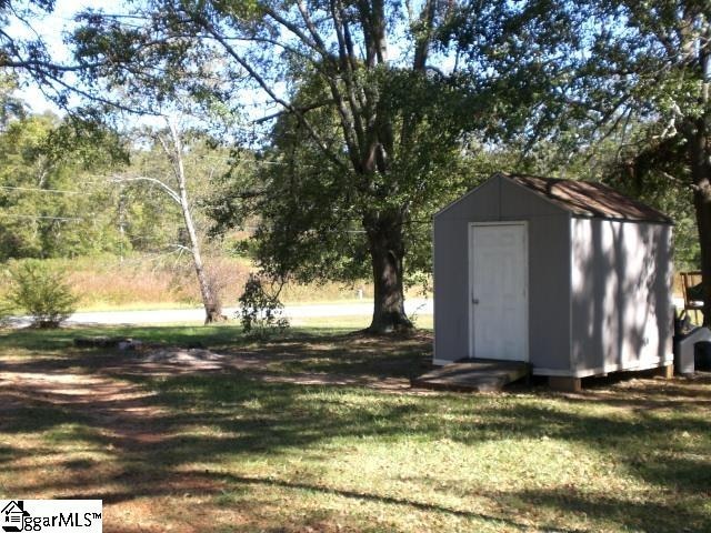 view of outbuilding featuring a yard