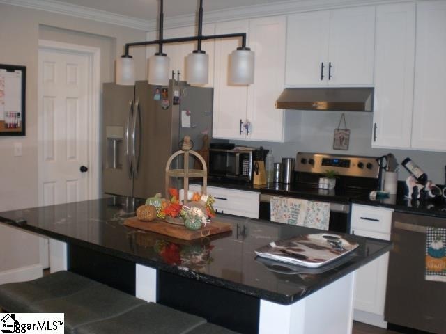 kitchen featuring a center island with sink, hanging light fixtures, white cabinetry, black appliances, and ventilation hood