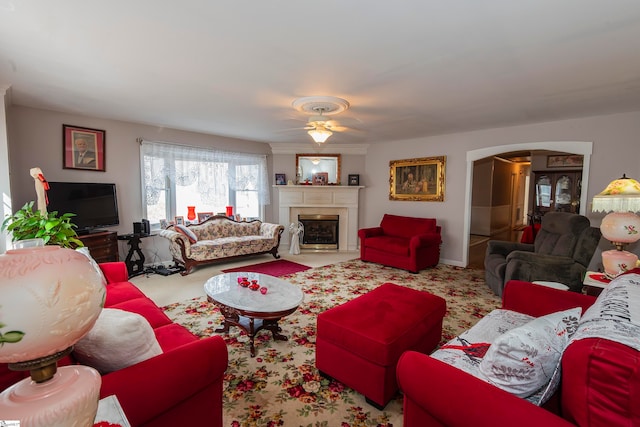 carpeted living room featuring ceiling fan