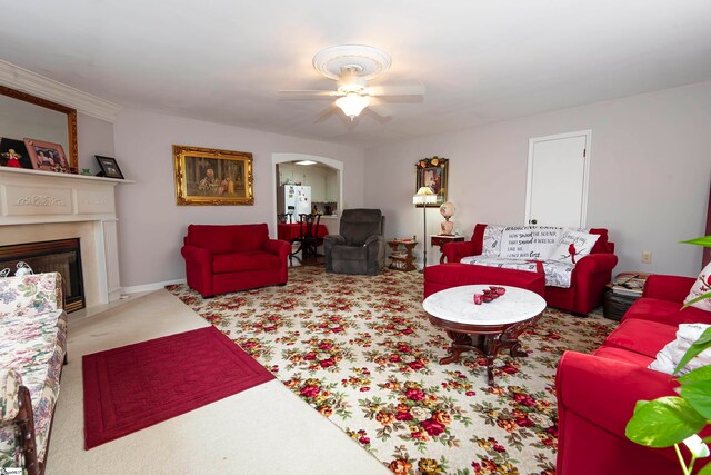 carpeted living room featuring ceiling fan