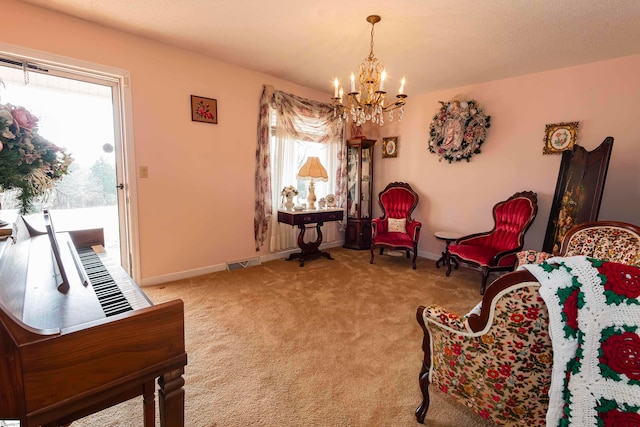 sitting room featuring a chandelier and carpet flooring