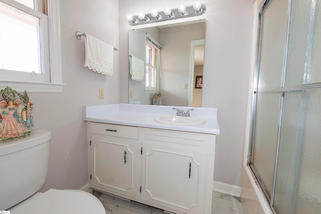 full bathroom with vanity, toilet, and a healthy amount of sunlight