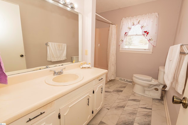 bathroom featuring toilet, vanity, and a shower with shower curtain