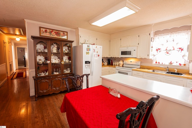 kitchen with white appliances, sink, a textured ceiling, white cabinetry, and dark hardwood / wood-style floors