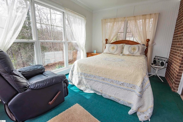 carpeted bedroom with brick wall, ornamental molding, and multiple windows