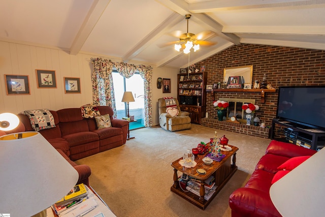 carpeted living room with vaulted ceiling with beams, brick wall, a fireplace, and ceiling fan