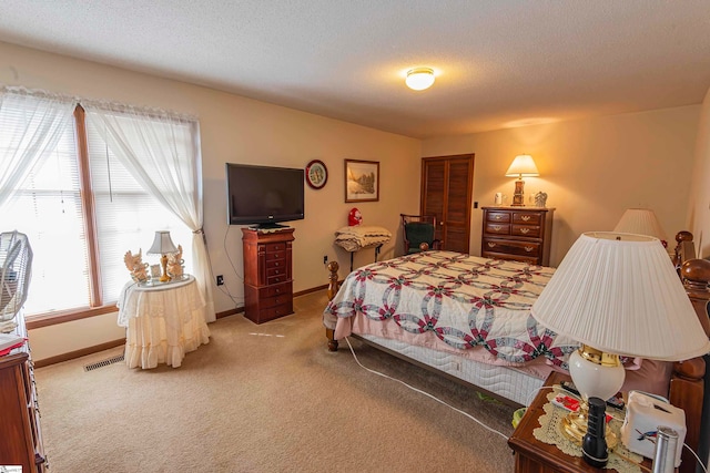 bedroom with a textured ceiling and carpet floors