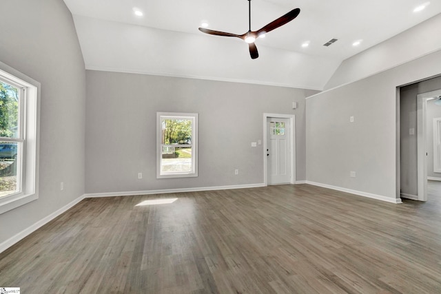 unfurnished living room with ceiling fan, plenty of natural light, lofted ceiling, and hardwood / wood-style flooring