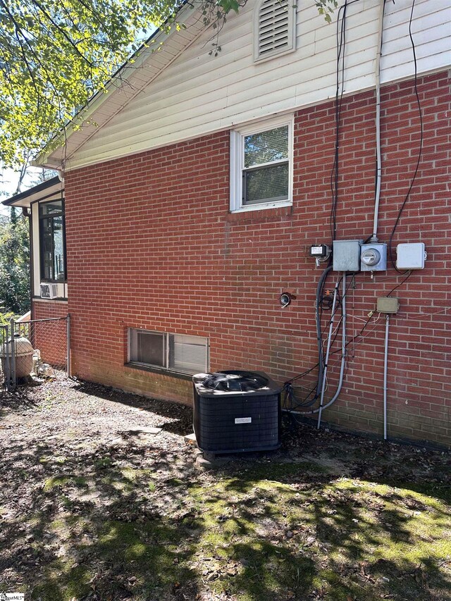 view of side of home featuring central AC