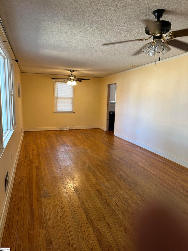 spare room featuring a textured ceiling, hardwood / wood-style flooring, and ceiling fan