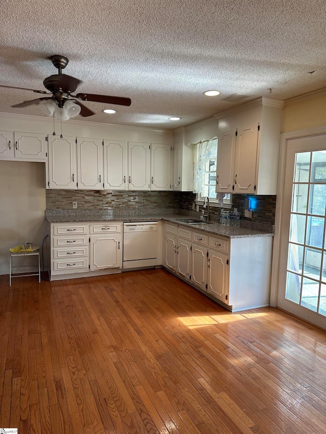 kitchen with dishwasher, white cabinets, a wealth of natural light, and light hardwood / wood-style flooring