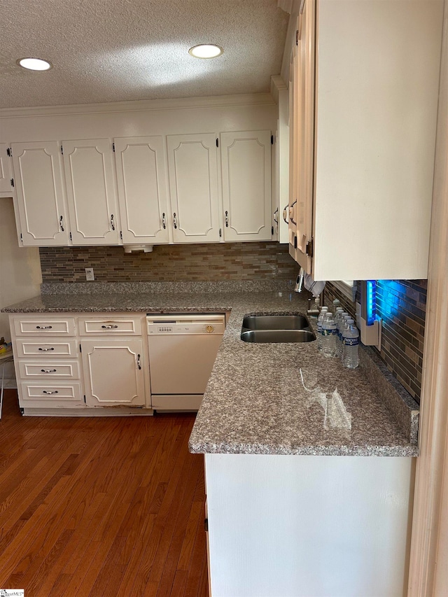 kitchen featuring white cabinets, decorative backsplash, and white dishwasher