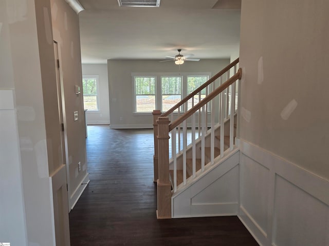 stairway with ceiling fan and hardwood / wood-style flooring