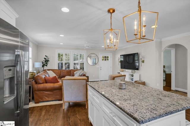 kitchen featuring a kitchen island, hanging light fixtures, stainless steel refrigerator with ice dispenser, white cabinetry, and dark hardwood / wood-style flooring