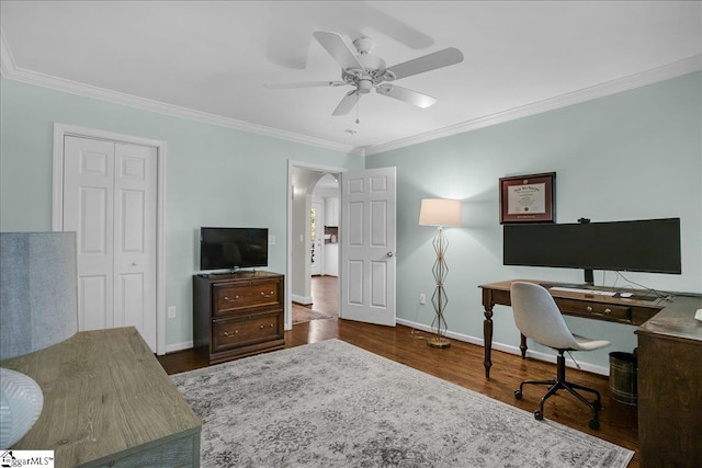 office space featuring dark wood-type flooring, ceiling fan, and ornamental molding