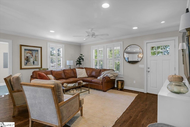 living room featuring a wealth of natural light, ornamental molding, and dark wood-type flooring