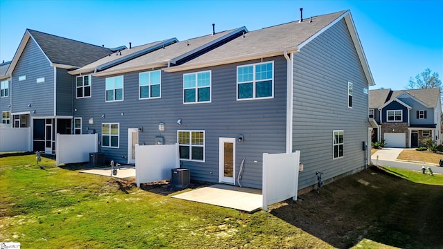 back of property with a patio, a yard, and central air condition unit