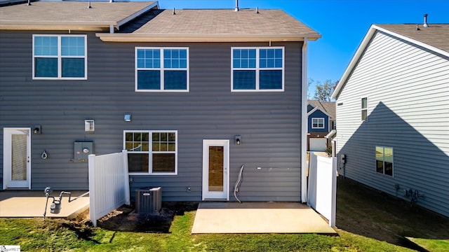 back of house with a patio, central AC, and a lawn