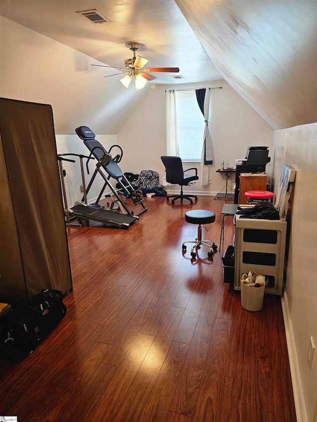 exercise room with lofted ceiling, dark wood-type flooring, and ceiling fan