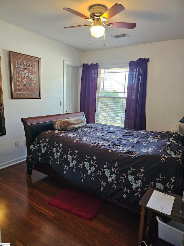 bedroom with ceiling fan and dark hardwood / wood-style floors