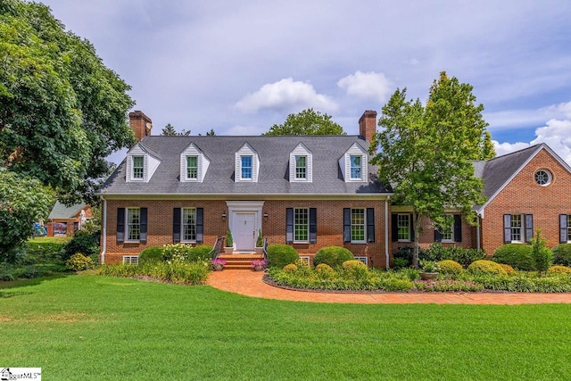 new england style home featuring a front yard