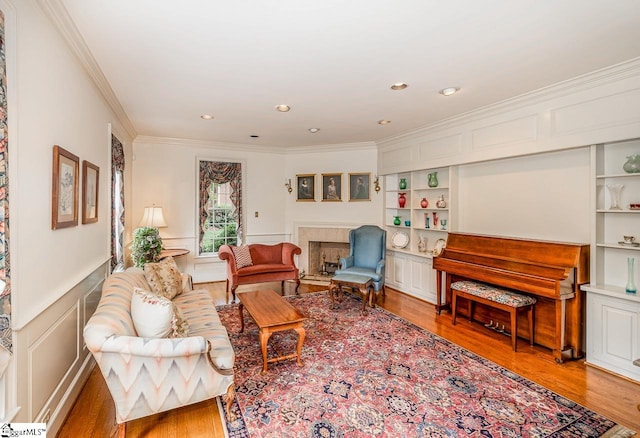 living room with crown molding and hardwood / wood-style flooring