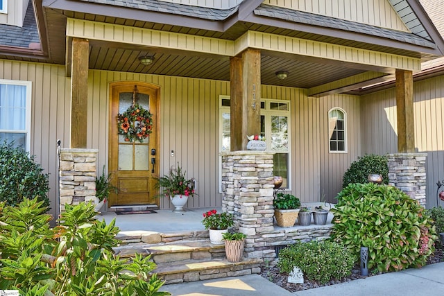 view of exterior entry with a porch