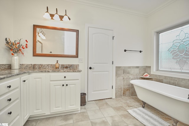 bathroom featuring a tub, tile walls, ornamental molding, vanity, and tile patterned flooring