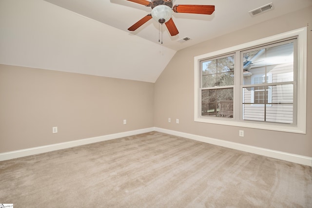 additional living space with lofted ceiling, light colored carpet, and ceiling fan