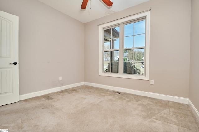 empty room featuring light carpet and ceiling fan