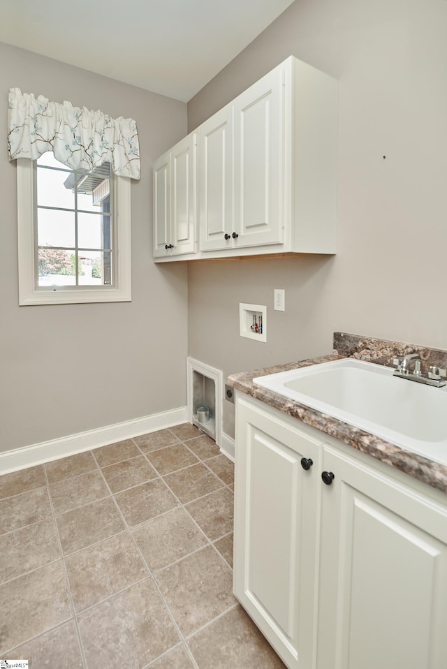 washroom featuring hookup for an electric dryer, hookup for a washing machine, cabinets, and light tile patterned floors