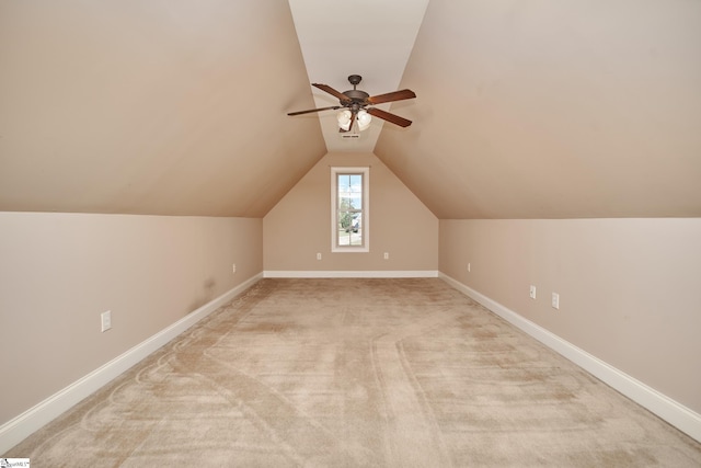 additional living space featuring vaulted ceiling, light carpet, and ceiling fan